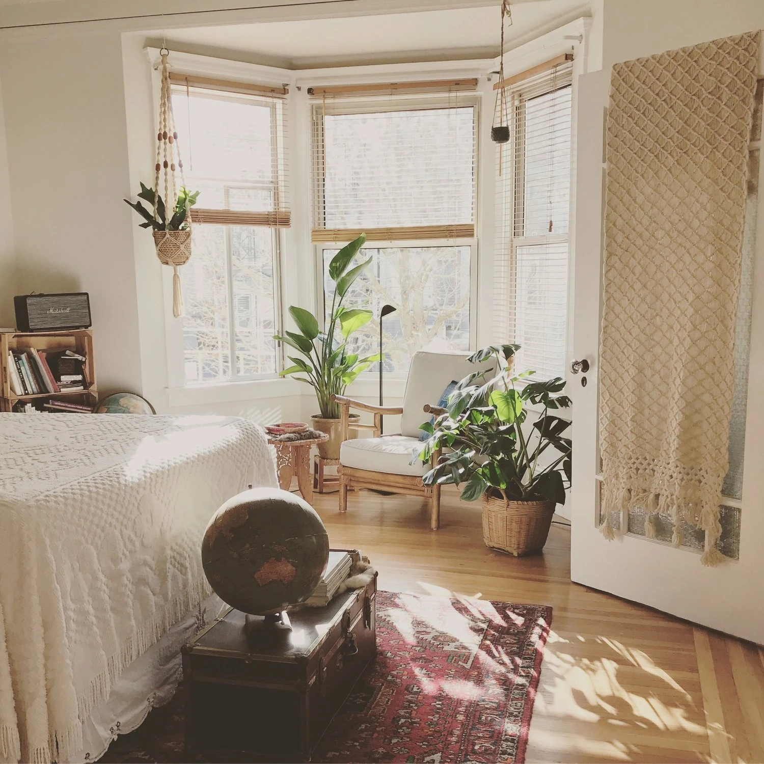 Room context: a sunlit bedroom with windows and clear space around furnishings
